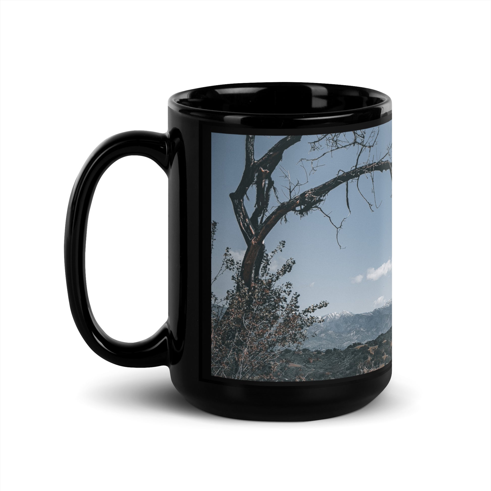 Glossy black mug with wrapped landscape photo; handle and front panel shown